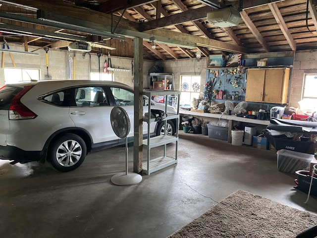 4441 Deckerville Rd, Lupton, MI 48635 - garage with a garage door opener and concrete block wall