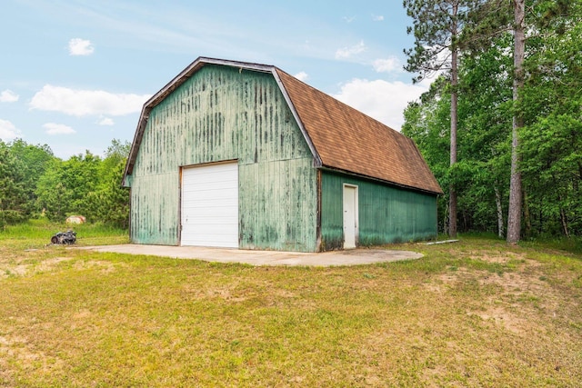 6038 SW Maple Hill Rd, Fife Lake, MI 49633 - view of barn featuring a yard and driveway