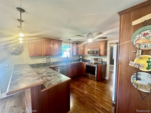 403 N Oak St, Durand, MI 48429 - kitchen featuring appliances with stainless steel finishes, a peninsula, dark wood-type flooring, hanging light fixtures, and ceiling fan
