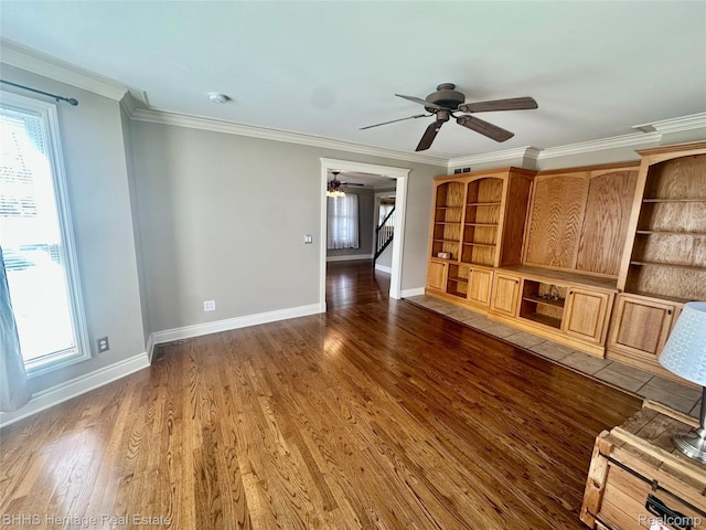 403 N Oak St, Durand, MI 48429 - unfurnished living room with a ceiling fan, plenty of natural light, wood finished floors, and ornamental molding