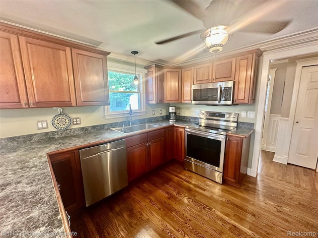 403 N Oak St, Durand, MI 48429 - kitchen featuring appliances with stainless steel finishes, dark wood-type flooring, crown molding, dark countertops, and ceiling fan