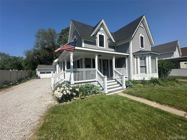 403 N Oak St, Durand, MI 48429 - view of front of property with a porch, a shingled roof, a front yard, and a garage
