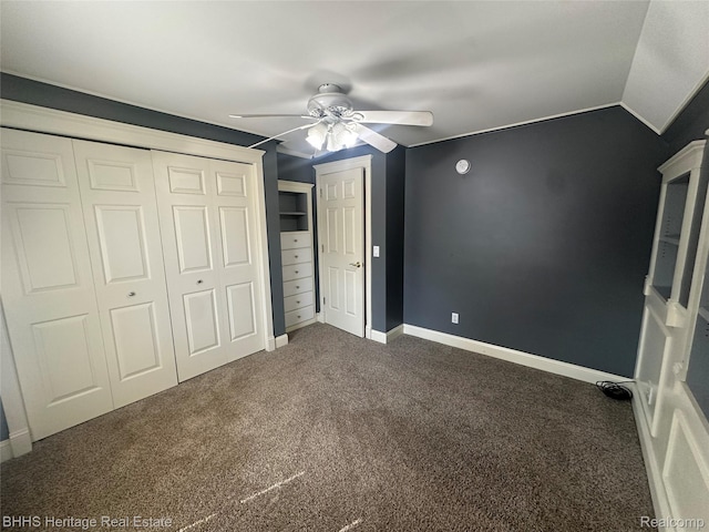 403 N Oak St, Durand, MI 48429 - unfurnished bedroom with dark carpet, a ceiling fan, and a closet