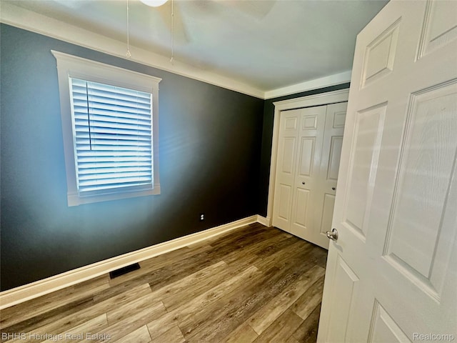 403 N Oak St, Durand, MI 48429 - unfurnished bedroom with dark wood-style flooring and baseboards