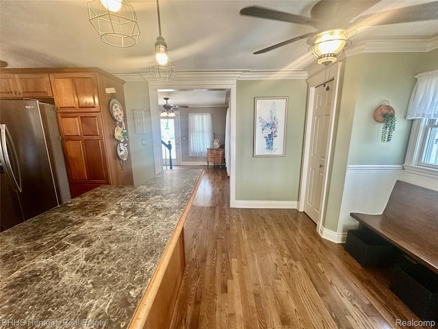 403 N Oak St, Durand, MI 48429 - kitchen featuring freestanding refrigerator, ceiling fan, ornamental molding, plenty of natural light, and wood finished floors
