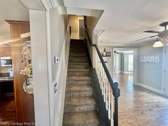 403 N Oak St, Durand, MI 48429 - stairs with ceiling fan, wood finished floors, and ornamental molding