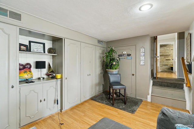 6003 Rolton Ct, Waterford, MI 48329 - sitting room featuring wood finished floors and stairway