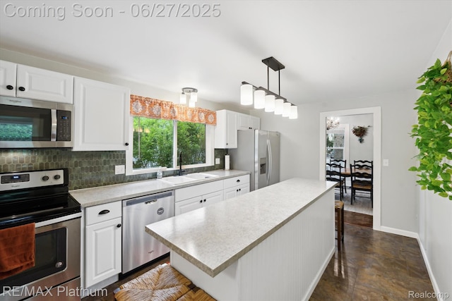 420 Wetmore St, Howell, MI 48843 - kitchen with appliances with stainless steel finishes, tasteful backsplash, light countertops, and white cabinetry