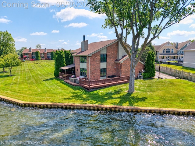 2226 Bowles St, Fenton, MI 48430 - rear view of property with a chimney, brick siding, a deck with water view, and a residential view