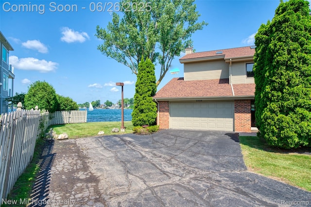 2226 Bowles St, Fenton, MI 48430 - view of property exterior with brick siding, asphalt driveway, a water view, and a chimney