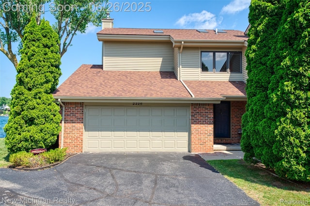 2226 Bowles St, Fenton, MI 48430 - view of front of house with brick siding, driveway, a chimney, a shingled roof, and a garage