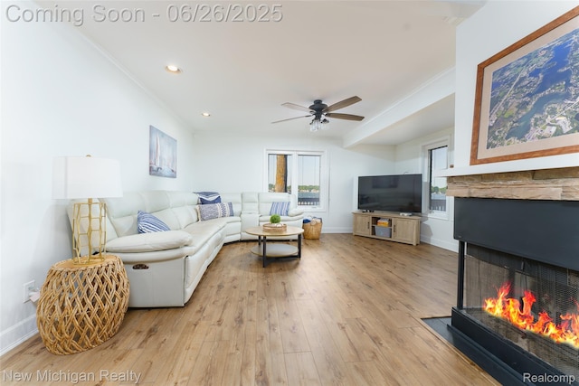 2226 Bowles St, Fenton, MI 48430 - living room featuring ceiling fan, light wood-style flooring, a multi sided fireplace, recessed lighting, and crown molding