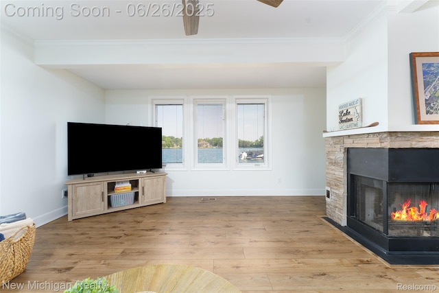 2226 Bowles St, Fenton, MI 48430 - living area featuring ornamental molding, light wood-style floors, ceiling fan, and a stone fireplace