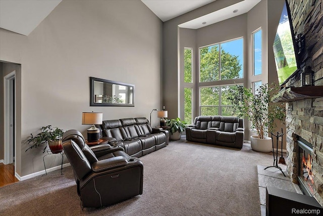 5390 Plantation Dr, Commerce Twp, MI 48382 - living room with a towering ceiling, carpet, and a stone fireplace