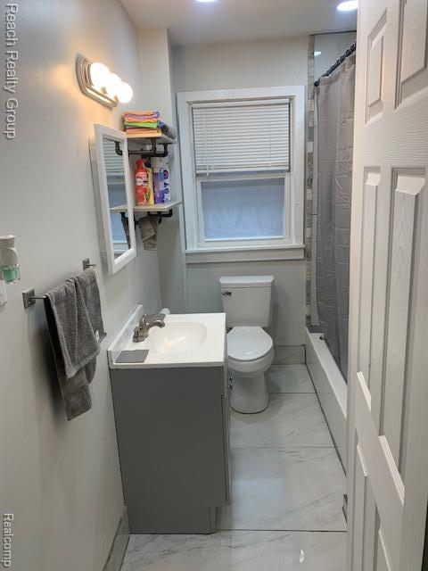 12066 N Martindale St, Detroit, MI 48204 - bathroom with vanity, marble finish flooring, and shower / bath combo