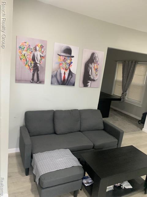 12066 N Martindale St, Detroit, MI 48204 - living room featuring baseboards and wood finished floors