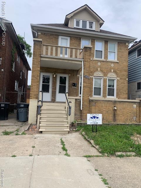 12066 N Martindale St, Detroit, MI 48204 - view of front of home with brick siding, a balcony, and entry steps