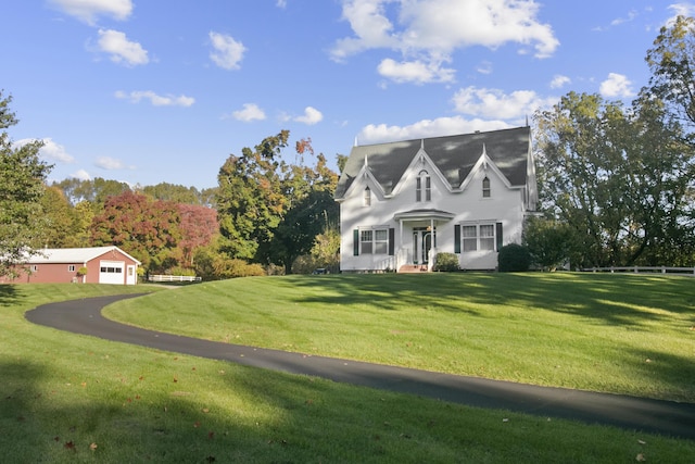 1532 34th St, Allegan, MI 49010 - view of front of property with a front yard, a detached garage, and asphalt driveway