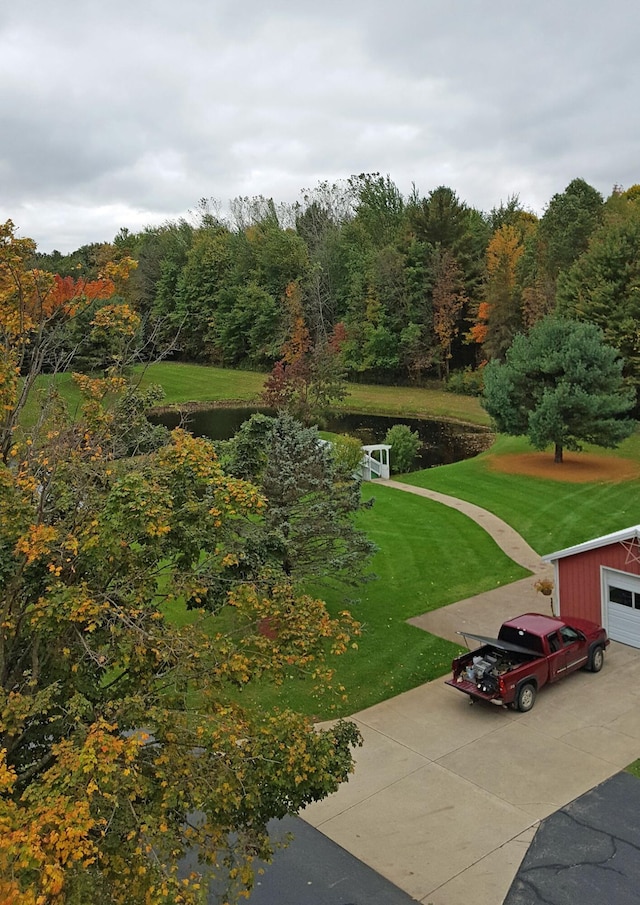 1532 34th St, Allegan, MI 49010 - surrounding community featuring a lawn, a water view, a view of trees, and a garage