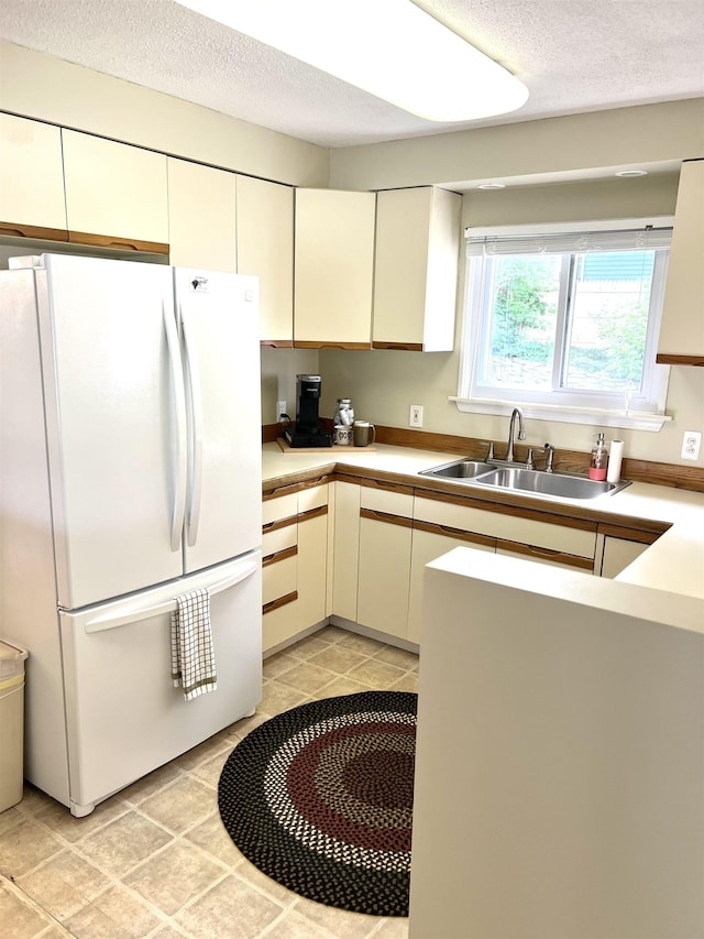 343 Bush Ave, Grand Blanc, MI 48439 - kitchen with freestanding refrigerator, light countertops, and a textured ceiling