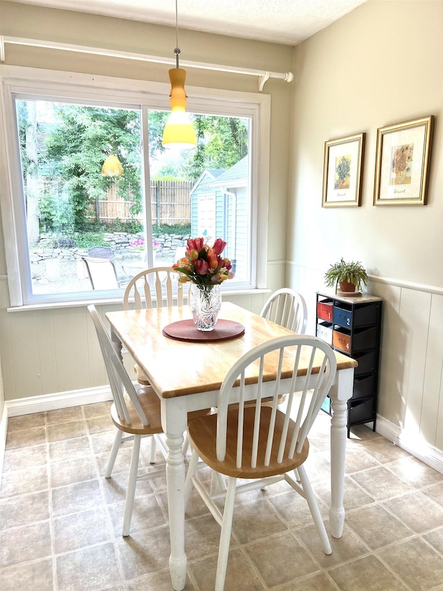 343 Bush Ave, Grand Blanc, MI 48439 - dining area featuring a decorative wall and wainscoting