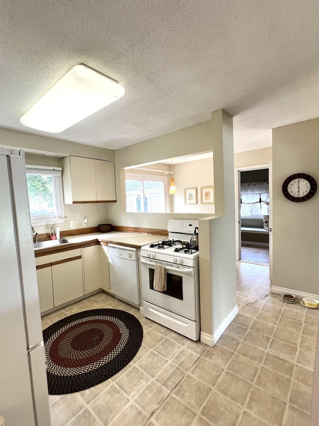 343 Bush Ave, Grand Blanc, MI 48439 - kitchen featuring white appliances, a textured ceiling, and light tile patterned flooring