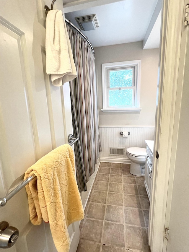 343 Bush Ave, Grand Blanc, MI 48439 - bathroom featuring vanity, a wainscoted wall, and a shower with shower curtain