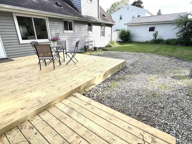 343 Bush Ave, Grand Blanc, MI 48439 - wooden deck featuring outdoor dining area and a lawn