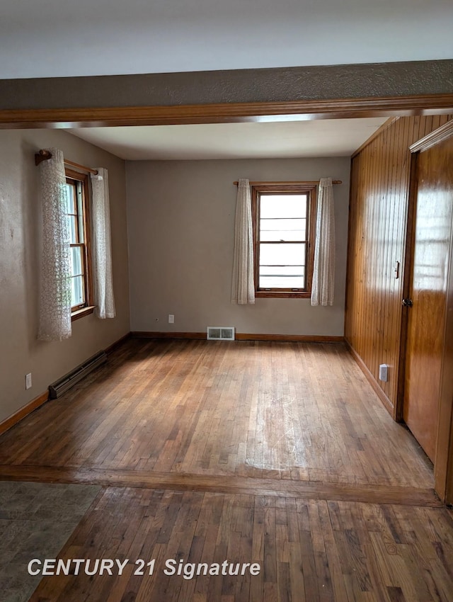 3344 Osler Ave, Saginaw, MI 48602 - spare room featuring baseboard heating, hardwood / wood-style floors, and plenty of natural light