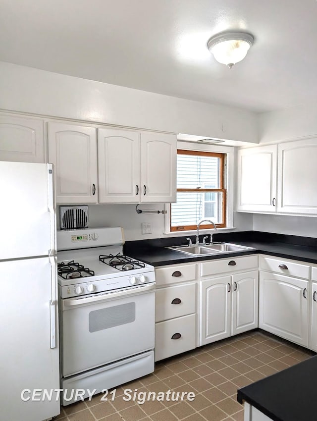 3344 Osler Ave, Saginaw, MI 48602 - kitchen featuring white appliances, dark countertops, white cabinets, and tile patterned flooring