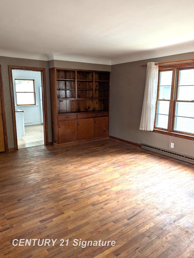 3344 Osler Ave, Saginaw, MI 48602 - spare room featuring a baseboard radiator and wood finished floors