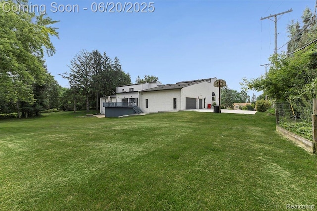 3440 Lone Pine Rd, West Bloomfield, MI 48323 - view of grassy yard featuring a wooden deck, an attached garage, and a garden