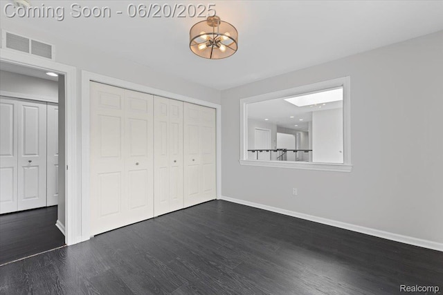 3440 Lone Pine Rd, West Bloomfield, MI 48323 - unfurnished bedroom featuring dark wood finished floors, a chandelier, and a closet