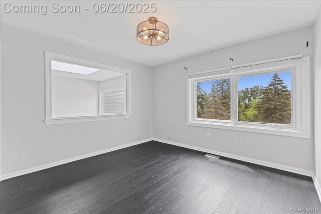 3440 Lone Pine Rd, West Bloomfield, MI 48323 - empty room with dark wood finished floors and a chandelier