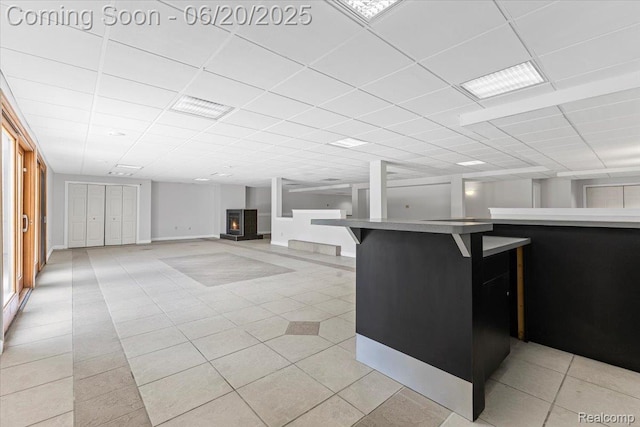 3440 Lone Pine Rd, West Bloomfield, MI 48323 - kitchen with light tile patterned floors, a paneled ceiling, a breakfast bar area, and light countertops