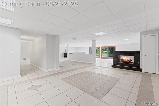3440 Lone Pine Rd, West Bloomfield, MI 48323 - unfurnished living room featuring tile patterned floors, a multi sided fireplace, and a drop ceiling