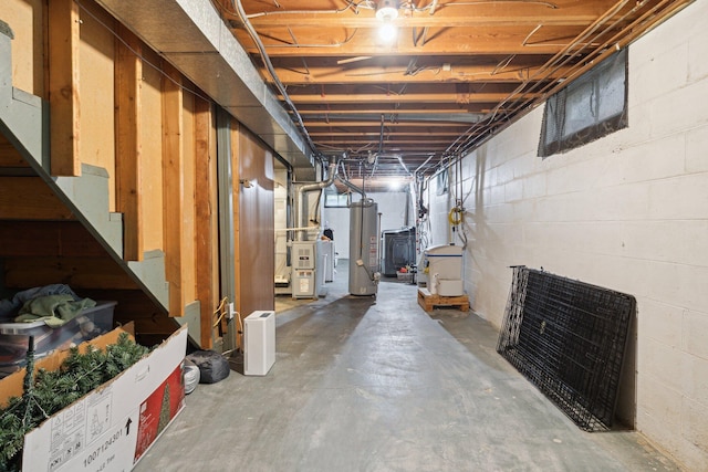 70838 Ridgewood Dr, Edwardsburg, MI 49112 - unfinished basement featuring gas water heater, concrete block wall, and stairway