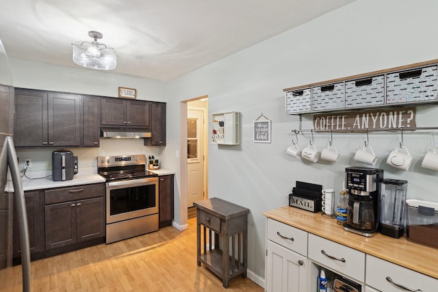 70838 Ridgewood Dr, Edwardsburg, MI 49112 - kitchen with electric range, under cabinet range hood, and light countertops