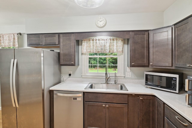 70838 Ridgewood Dr, Edwardsburg, MI 49112 - kitchen featuring appliances with stainless steel finishes, dark brown cabinetry, and light countertops
