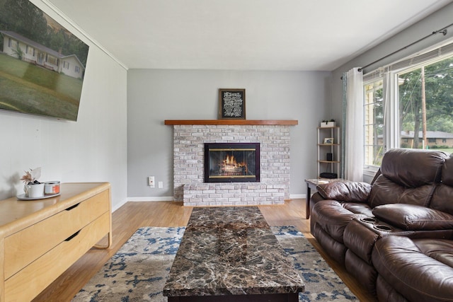 70838 Ridgewood Dr, Edwardsburg, MI 49112 - living room with a brick fireplace and light wood-style floors