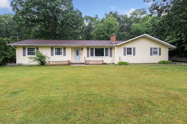 70838 Ridgewood Dr, Edwardsburg, MI 49112 - ranch-style home with a front yard, a chimney, and view of wooded area