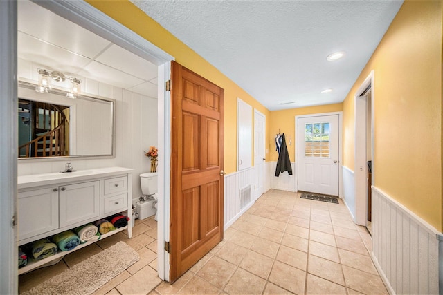 13674 Lenore Dr, Hudson, MI 49247 - hallway featuring wainscoting, light tile patterned floors, and recessed lighting