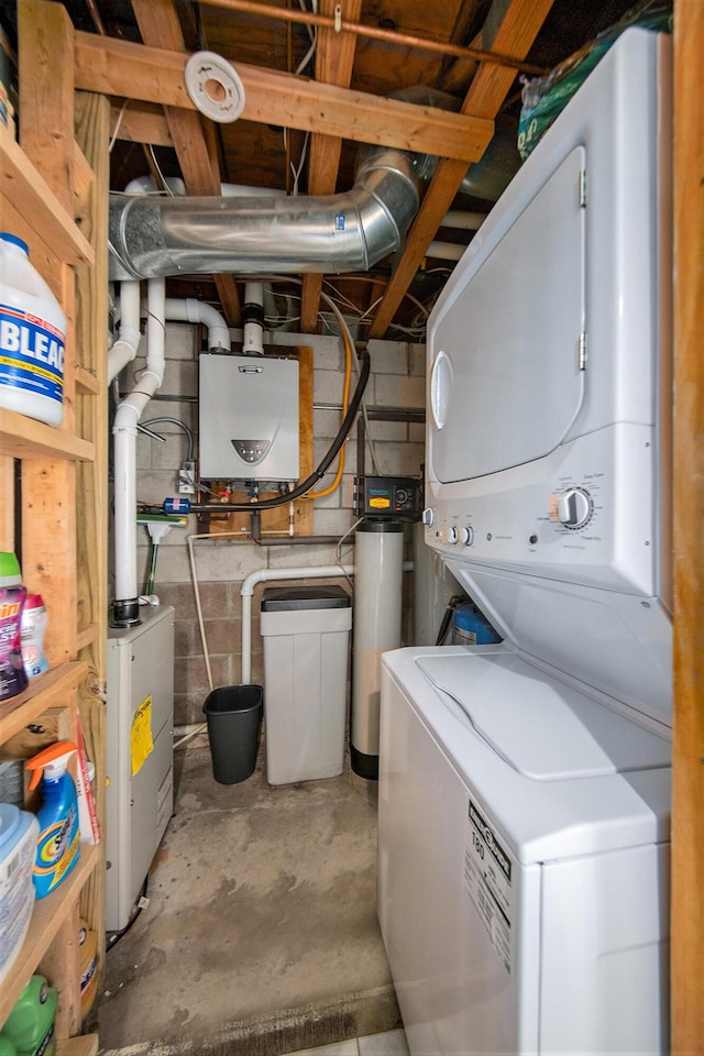 13674 Lenore Dr, Hudson, MI 49247 - laundry room featuring stacked washer and clothes dryer, tankless water heater, and concrete block wall
