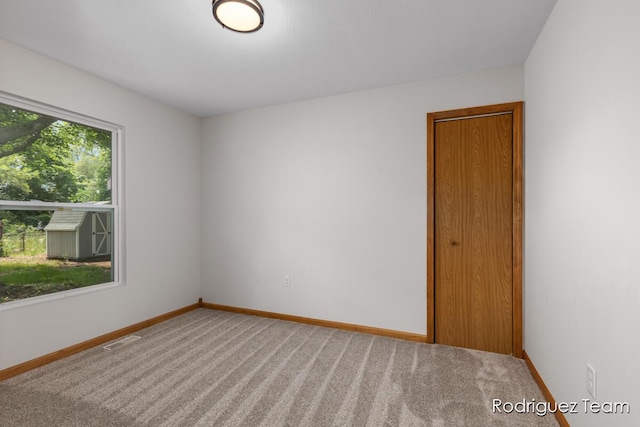 1235 Aurora Ave, Muskegon, MI 49442 - carpeted spare room with baseboards