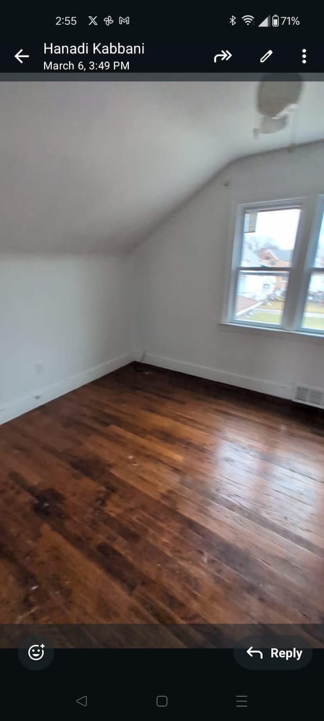 7761 Artesian St, Detroit, MI 48228 - additional living space with vaulted ceiling and dark wood-style flooring