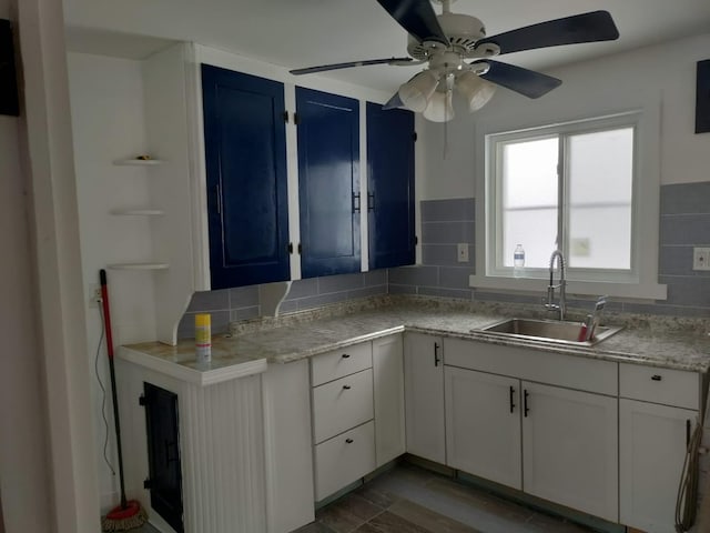 7761 Artesian St, Detroit, MI 48228 - kitchen with ceiling fan, light countertops, decorative backsplash, and white cabinetry