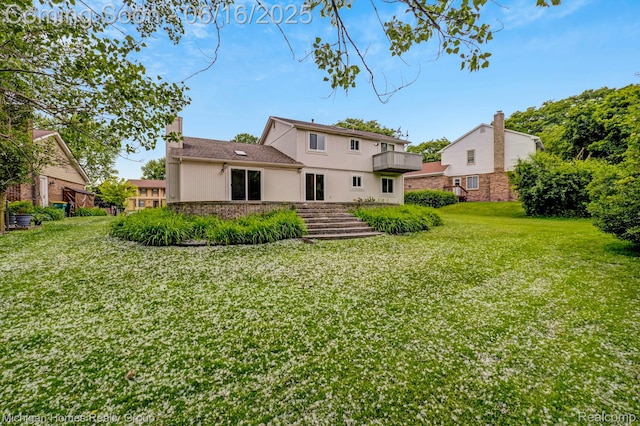 34516 Bunker Hill Dr, Farmington, MI 48331 - back of property with a yard, stucco siding, a chimney, and brick siding