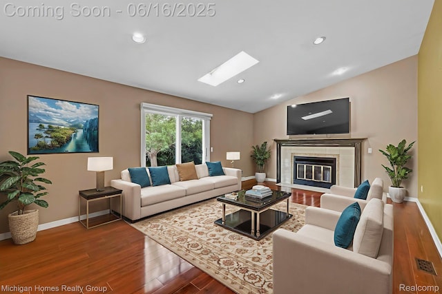 34516 Bunker Hill Dr, Farmington, MI 48331 - living room with wood finished floors, a skylight, lofted ceiling, a tile fireplace, and recessed lighting