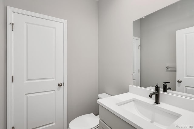 1058 Hampton Cir Unit 74, Detroit, MI 48207 - half bathroom featuring vanity and toilet