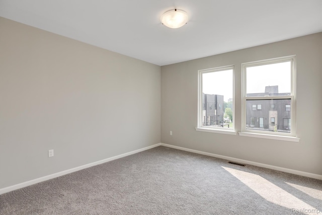 1058 Hampton Cir Unit 74, Detroit, MI 48207 - carpeted empty room featuring baseboards